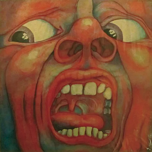 Original In the Court of the Crimson King cover showing a painted red face with wide eyes and an open mouth