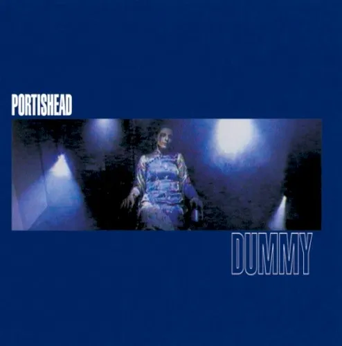 Original Dummy album cover with a blue field and a film still of singer Beth Gibbons seated beneath stage lights